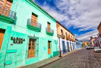 Street amidst buildings against sky in city