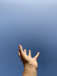 Close-up of hand against clear sky