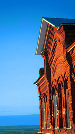 Low angle view of temple against clear blue sky