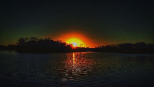Scenic view of lake at sunset