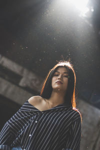 Portrait of young woman standing in abandoned building