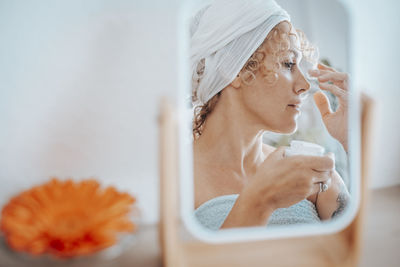 Mature woman applying face cream