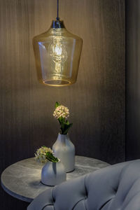 Close-up of illuminated lamp on table