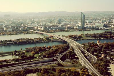 High angle view of bridge over river amidst buildings in city