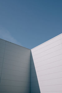 Low angle view of building against clear blue sky