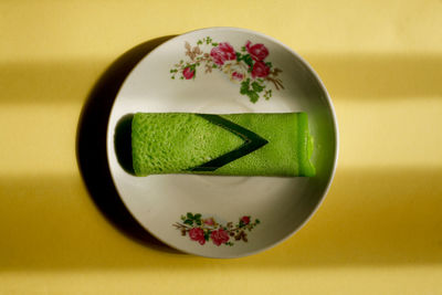 High angle view of rolled pandan pancake on table