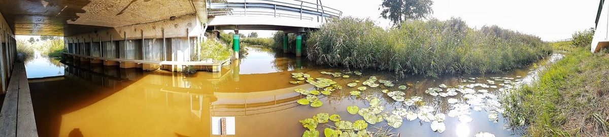 Panoramic view of bridge over river against sky