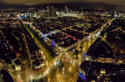 Aerial view of illuminated cityscape against sky at night