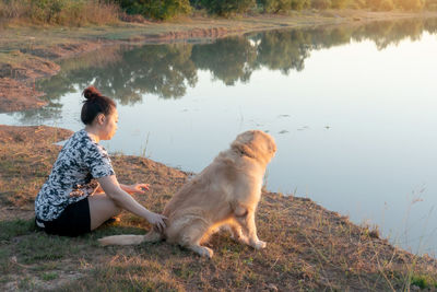 Woman with dog by lake