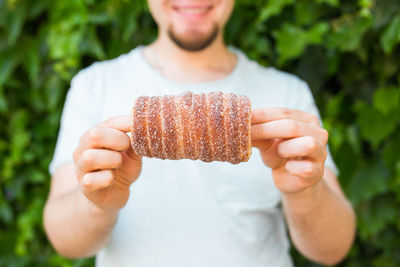 Midsection of man holding ice cream