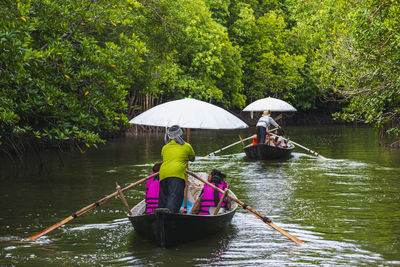 Boat trip bringing tourists to see the mangrove forest in ko lanta, krabi, thailand.