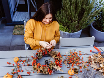 Woman sitting on table