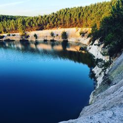 Scenic view of lake in forest against sky