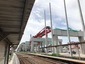 Train at railroad station against sky