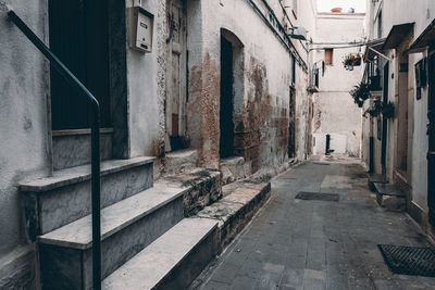 Empty alley amidst buildings in city