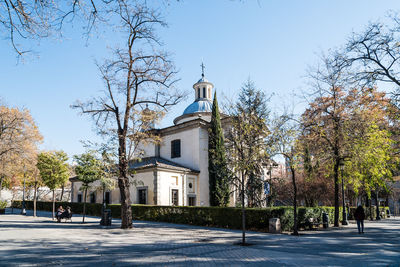 View of church in city against clear sky