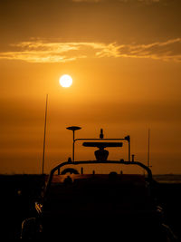 Silhouette boat against sky during sunset