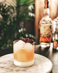 Close-up of orange drink served on table