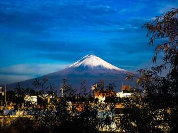 View of illuminated snowcapped mountain against sky