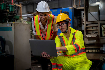 Full length of man working with mobile phone