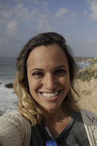 Close-up portrait of smiling woman at beach