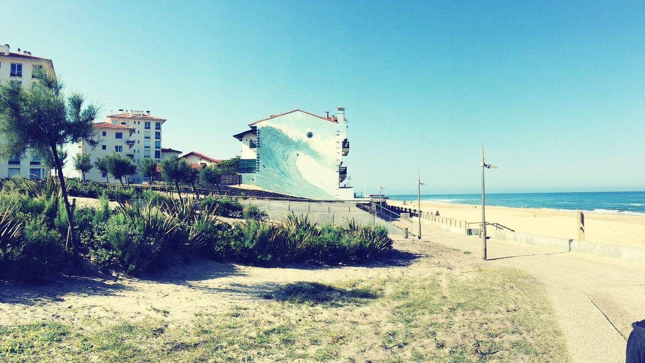 VIEW OF CALM BEACH AGAINST CLEAR SKY