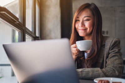 Portrait of woman drinking coffee cup