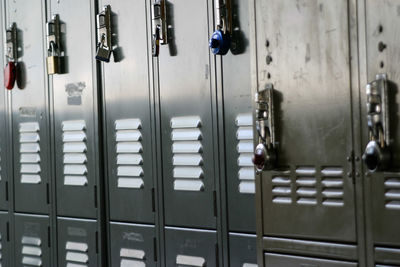 Full frame shot of metallic lockers with padlocks