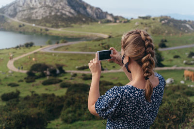 Woman photographing on mobile phone