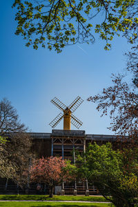 Low angle view of traditional windmill against sky