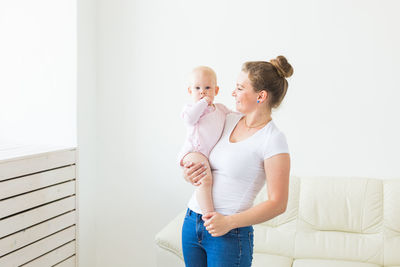 Mother and daughter holding baby