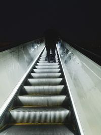 Rear view of man on escalator