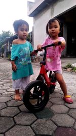 Portrait of cute girl on footpath