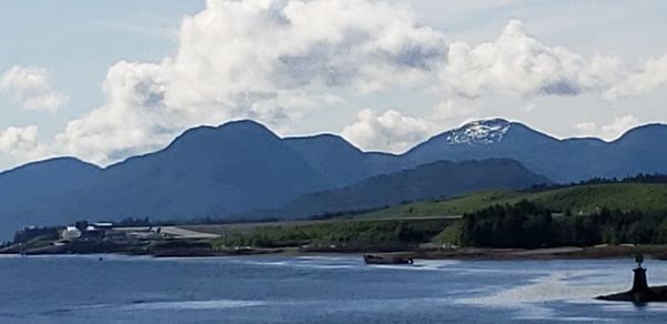 Scenic view of mountains against cloudy sky