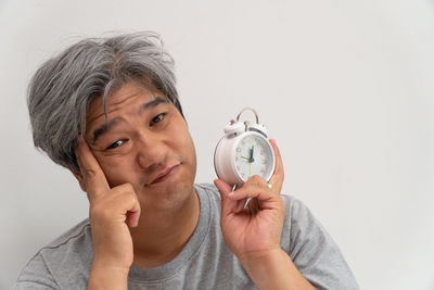 Close-up portrait of man wearing mask against white background