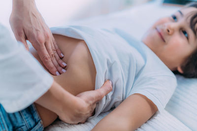 Pediatrician gastroenterologist, doing abdominal examination to a preschooler boy