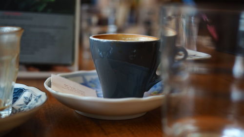 Close-up of coffee served on table at cafe