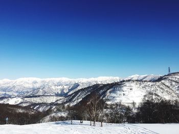 Scenic view of snow covered mountain against clear sky