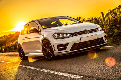 Car on road against sky during sunset