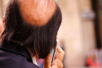 Cropped image of woman holding smart phone