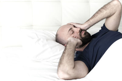 High angle view of man sleeping on bed at home