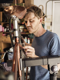 Mechanic installing bicycle at workshop