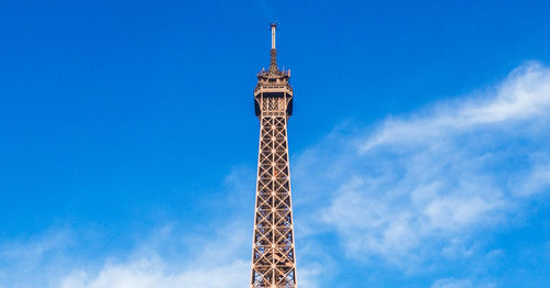 Low angle view of eiffel tower against cloudy sky in paris. 