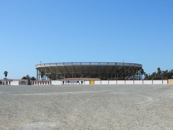 Built structure on beach against clear blue sky