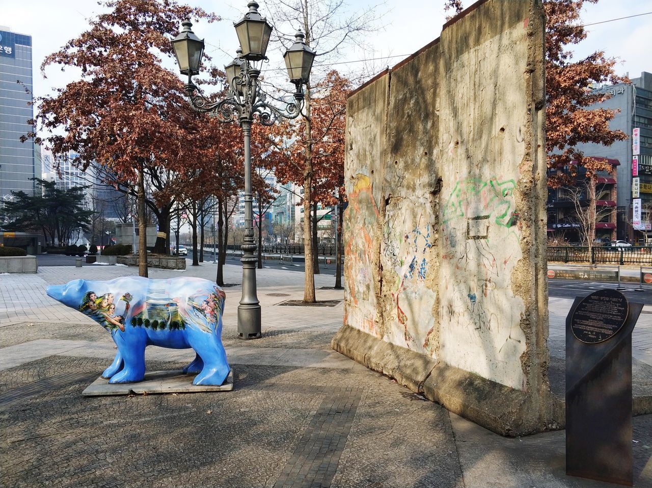 TREES IN CITY AGAINST BUILT STRUCTURE