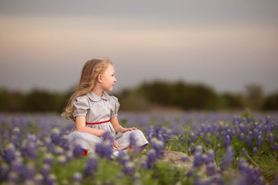 Portrait of smiling girl standing amidst flowers