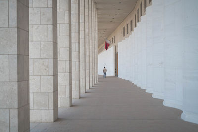 Rear view of man walking in corridor