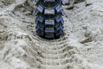 Close-up of tire track in sand
