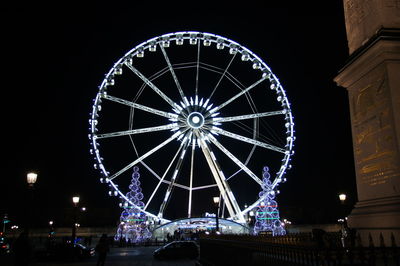 Illuminated ferris wheel at night