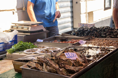 Midsection of man working at market stall